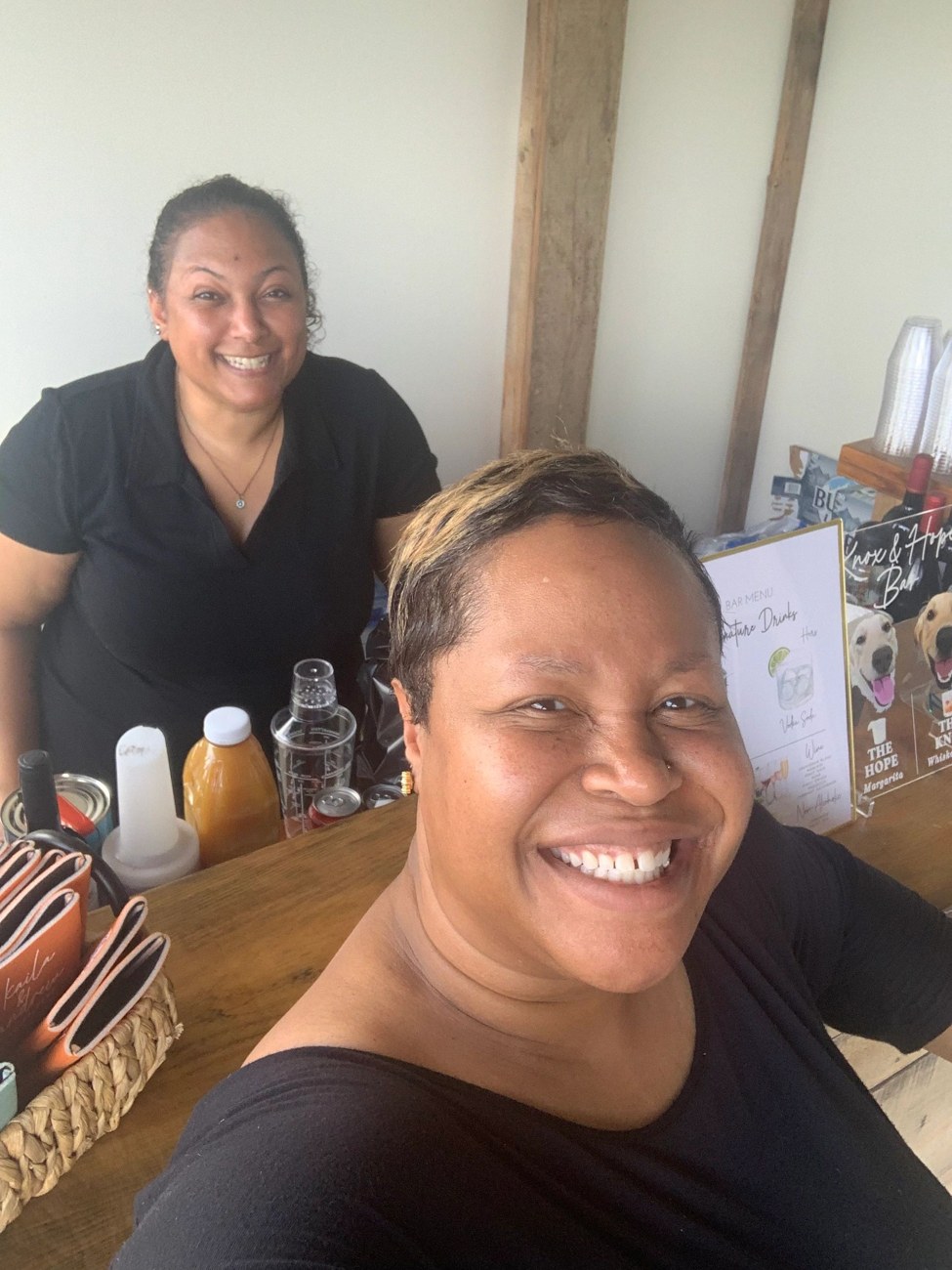 Smiling bartending team at a wedding bar